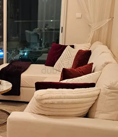 L-shaped white fabric corner sofa with chaise - good condition.