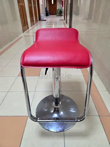 Red adjustable bar stool with chrome base