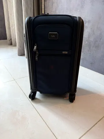 Medium navy soft-shell carry-on suitcase with spinner wheels