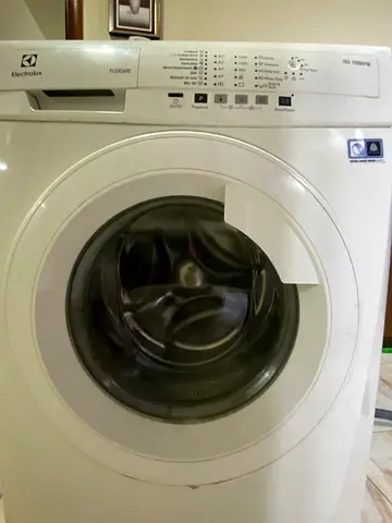 Electrolux front load washing machine - drum broken can be repaired and used or use for parts.