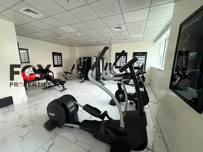Luxurious and largest two-bedroom apartment with a living room for annual rent in Al Waha Tower, Al Rashidiya 1 area,furnished with high-end furniture