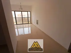 2BR in Al Alia, Ajman, large space, balcony, 2 baths, central AC, new building, AED 39,997/year.