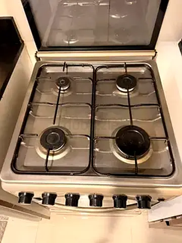 Used 4-Burner Stainless Steel Gas Stove with Oven - Good Working Condition