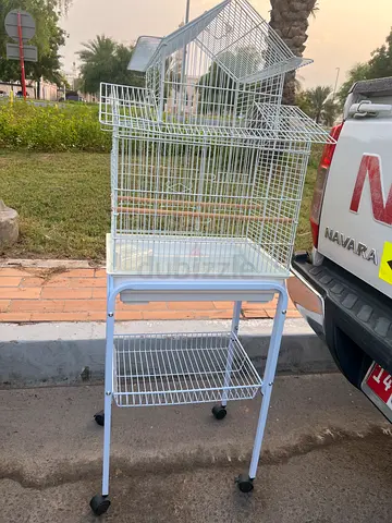 White metal bird cage on stand with wheels - good condition