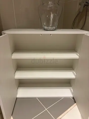 White bathroom wood cabinet with vertical shelving