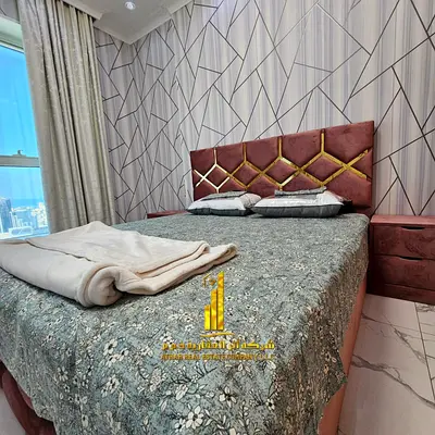 Luxury two-bedroom apartment with a living room in Ajman - Al Rashidiya 1 - Oasis Towers - furnished with hotel-style furniture for monthly rent
