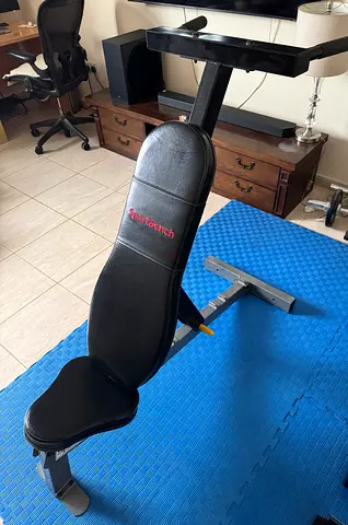 Adjustable weight bench with dip bar attachment