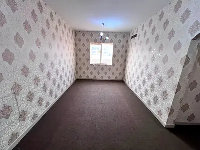 Two-bedroom apartment with a living room for annual rent in Al Rawda 2- Ajman, directly on Sheikh Ammar Street, with a large area and a prime location