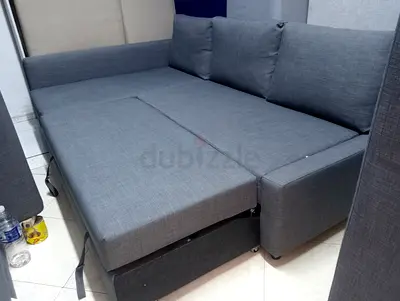 Grey L-shaped sofa bed in good condition (pull-out bed)