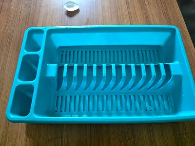 Blue plastic dish rack with cutlery holders