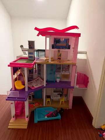 Large multi-level Barbie-style dollhouse with furniture and accessories