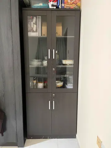 Tall dark wood storage cabinet with glass doors — good condition