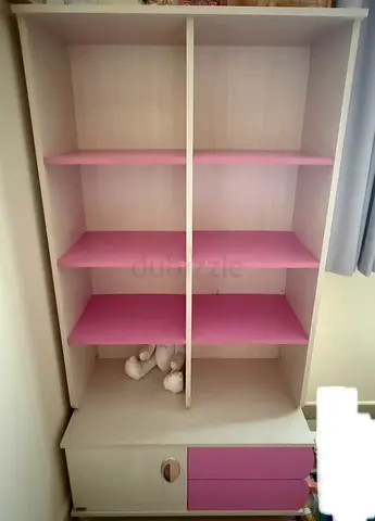Pink bookcase with drawers and side cabinet