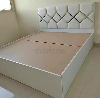 Queen size white upholstered platform bed with storage base
