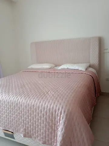 Queen bed frame with padded headboard - light pink