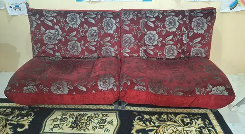 Red floral two-seater floor sofa / futon in good used condition