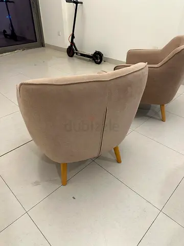Pair of beige upholstered ottomans / footstools with wooden legs