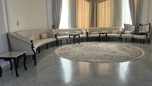 Large cream curved living room sofa set with matching tables and round rug