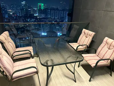 6-piece balcony dining set with glass table and cushioned chairs
