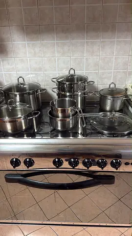 Set of stainless steel pots and pans with lids