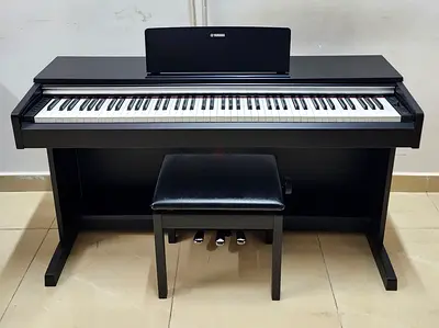 The Yamaha Arius YDP-142B is an 88-key home digital piano featuring a black walnut finish, Graded