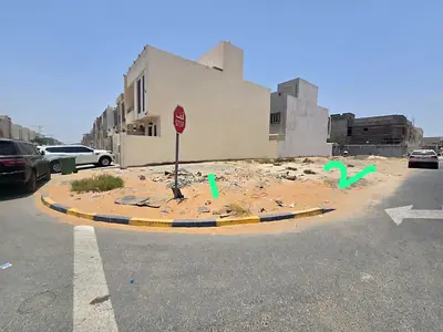 Two corner residential plots for sale in a prime location in Al Yasmin area