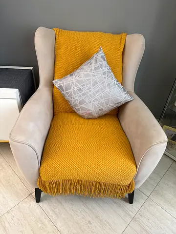 Beige wingback armchair with mustard throw and cushion - good condition