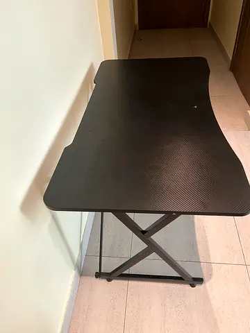 Black folding metal table — compact, sturdy, good condition