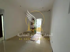 A spacious one-bedroom apartment with a living room and balcony in Al Qulaya featuring central air c