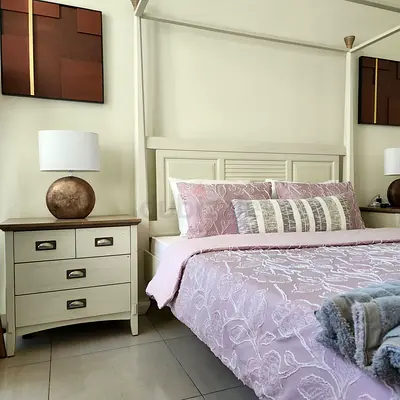 White wooden canopy bed with matching bedside cabinet - good condition