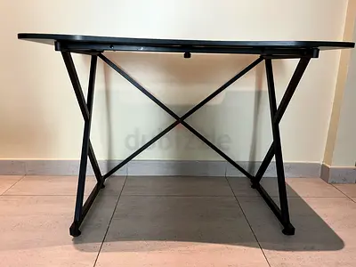 Black folding metal table — compact, sturdy, good condition