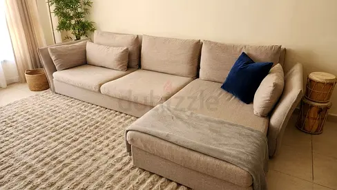 HomeRus Light beige L-shaped fabric sofa with chaise - good condition.