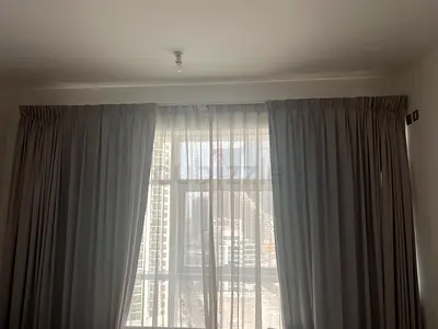 Light grey full-length black out curtains with sheer lining