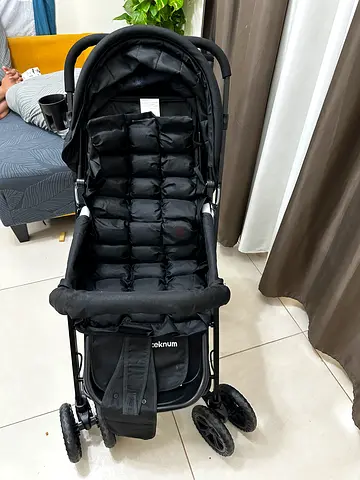 Lightly used black stroller with padded seat and adjustable handle