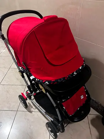 Red standard baby stroller in good condition