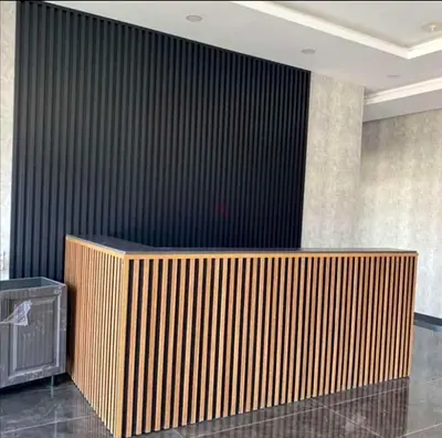 Custom Made Fluted Reception Counter with Vertical Wood Slat Design and Elegant Black Accent Finish