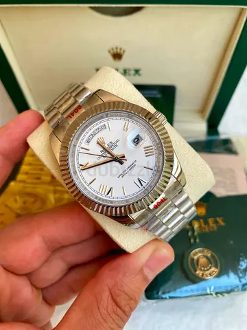 This appears to be a Rolex Day-Date featuring a white dial, fluted bezel, and President bracelet.