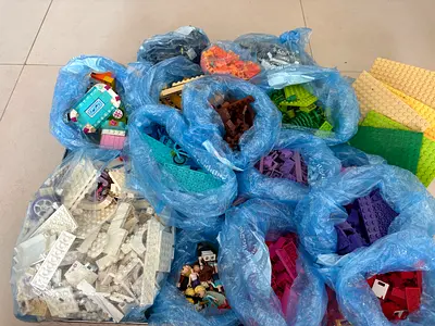 ASSORTED legos separated by colour, includes lego friends hotel and lego harry potter quidditch