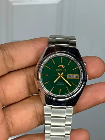 Orient Crystal 3 Star automatic watch featuring a distinctive green dial