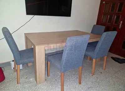 Wooden dining table with 4 grey upholstered chairs