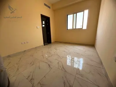 For annual rent in Ajman, Al Alia area: a brand new, fully furnished apartment with two bedrooms and a living room, balcony, and super deluxe finishin