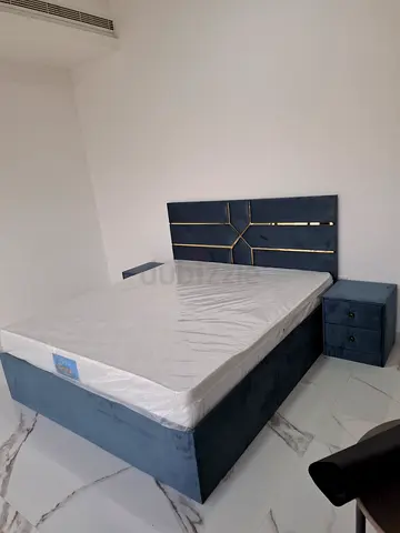 Blue fabric edition king size bed with matching bedside table