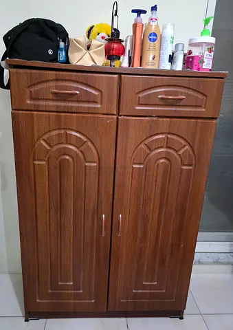 Compact wooden cabinet with drawers and double doors - good condition. Shoe rack