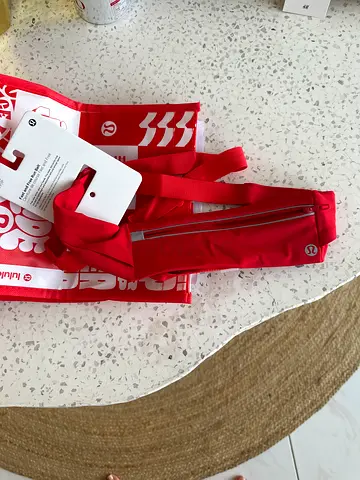 Brand new red athletic waist/shoulder Lululemon-style pouch with tags. Size XS/S