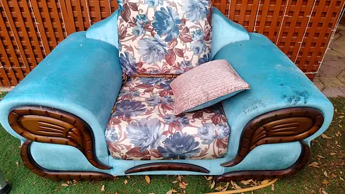 Used single-seater upholstered armchair - blue floral cushion, wooden trim