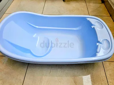 Light blue baby bathtub with built-in seat and soap holders