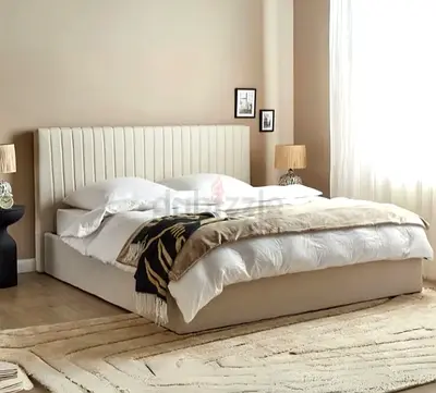 Beige upholstered double bed with padded headboard — modern design