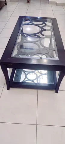 Dark wood glass-top coffee table with mirror lower shelf