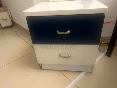 Small two-drawer bedside cabinet in blue and white