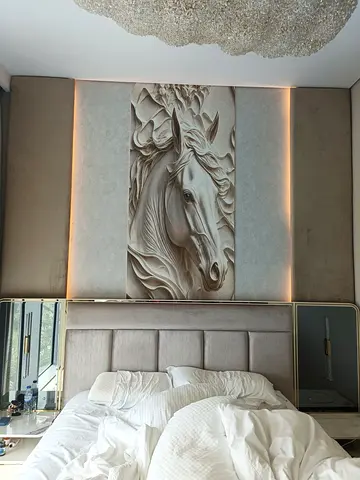 King-size upholstered bed with carved horse head feature wall